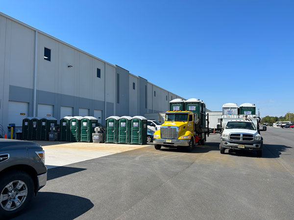 row of Complete Site Solutions portable toilets outside building